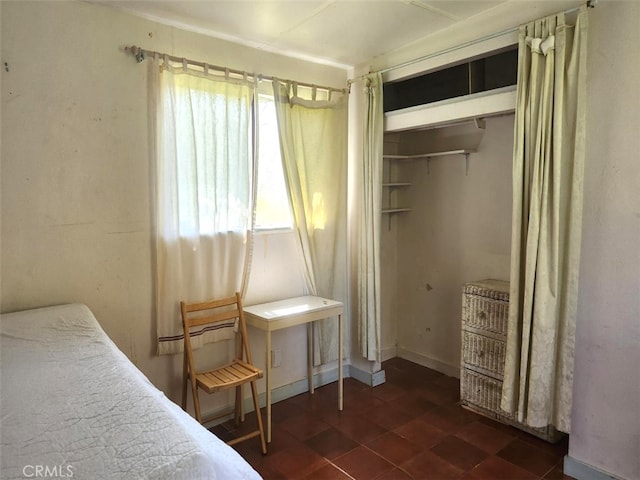 bedroom featuring a closet and multiple windows