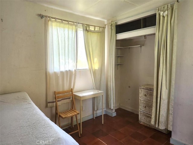bedroom with a closet and dark floors