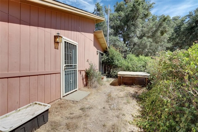 view of side of property featuring a hot tub