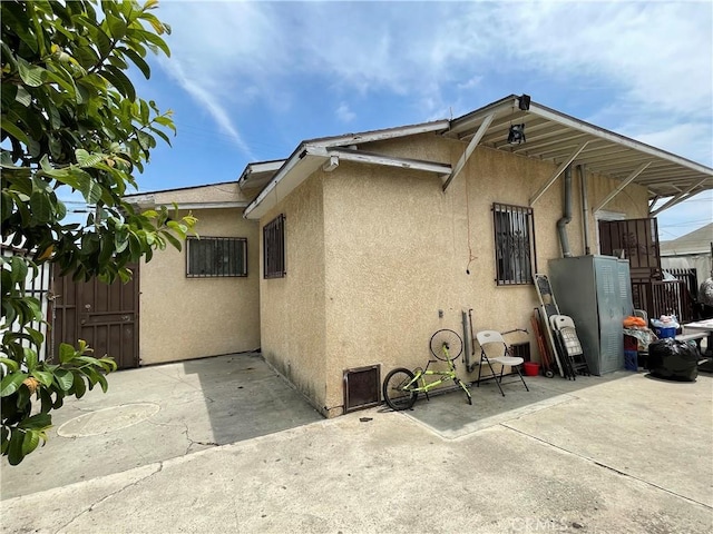 view of side of property featuring a patio