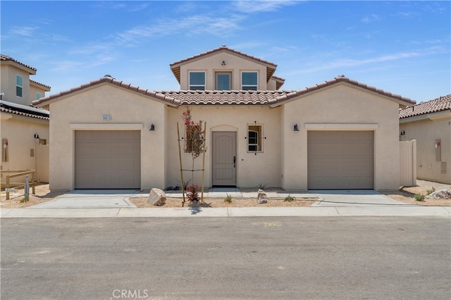 mediterranean / spanish house with a garage