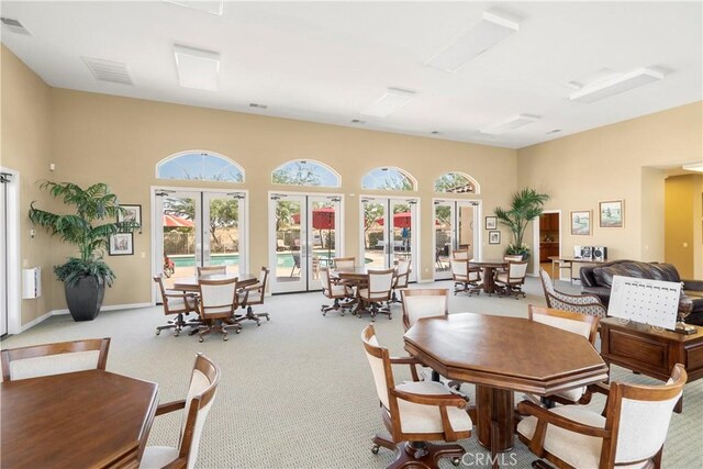 carpeted dining area featuring french doors