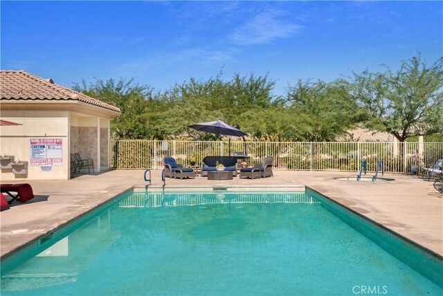 view of swimming pool with outdoor lounge area and a patio