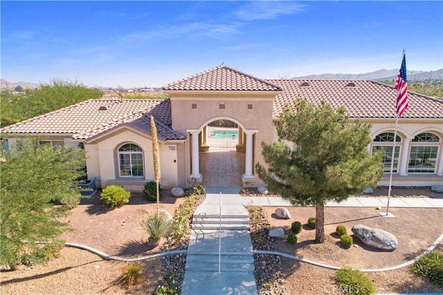 mediterranean / spanish house featuring a mountain view