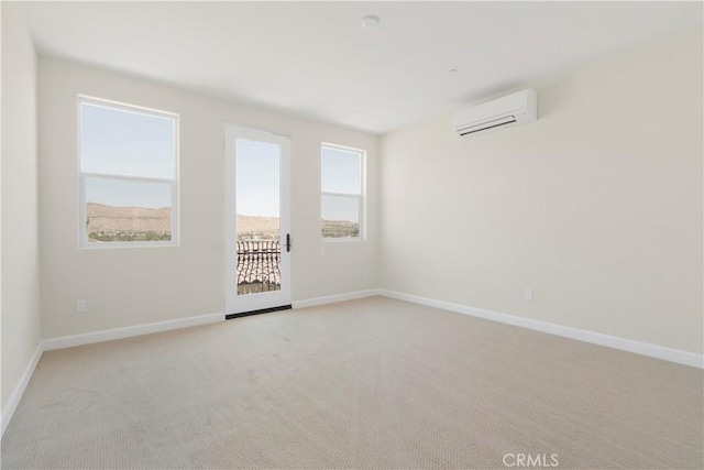 unfurnished room with light colored carpet and a wall mounted air conditioner