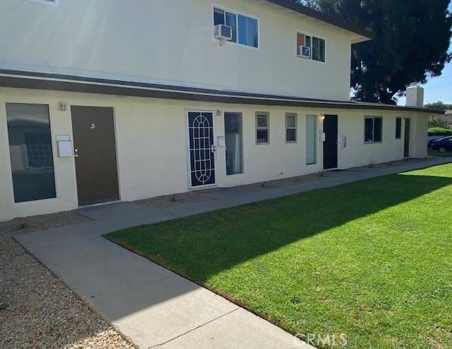 rear view of property with a yard and a patio area