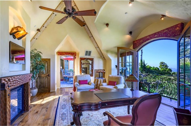 office area featuring beam ceiling, a wealth of natural light, light hardwood / wood-style flooring, and high vaulted ceiling