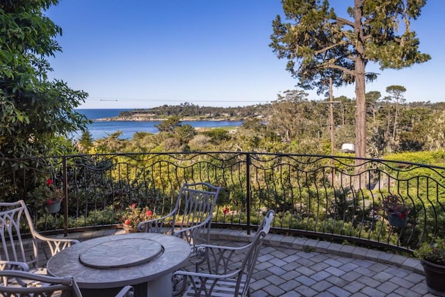 balcony featuring a patio and a water view