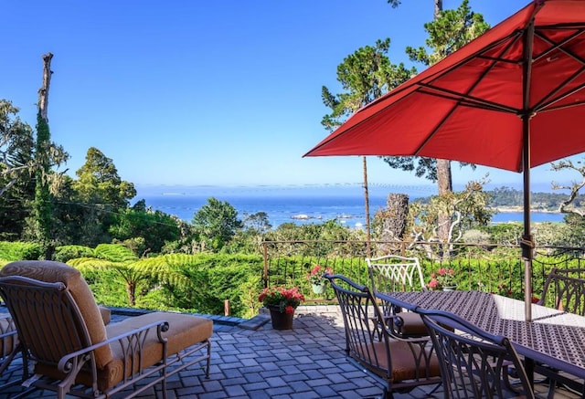 view of patio with a water view