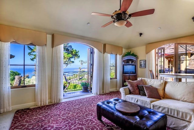 carpeted living room with ceiling fan and a healthy amount of sunlight