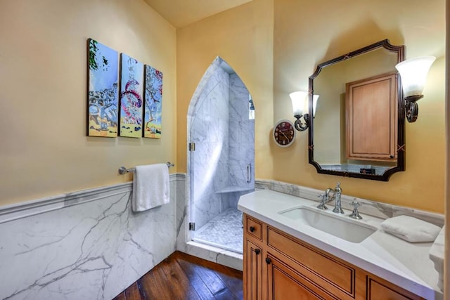 bathroom with vanity, wood-type flooring, and an enclosed shower