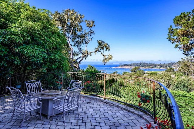 view of patio featuring a water view and an outdoor fire pit