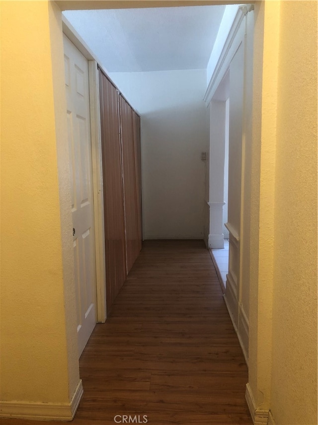 corridor featuring dark wood-type flooring