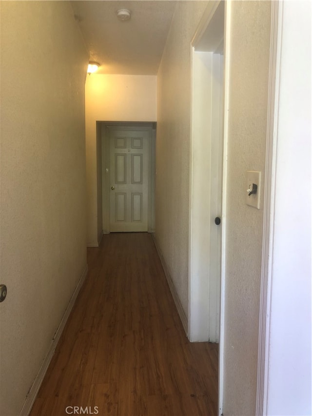 hallway with dark wood-type flooring