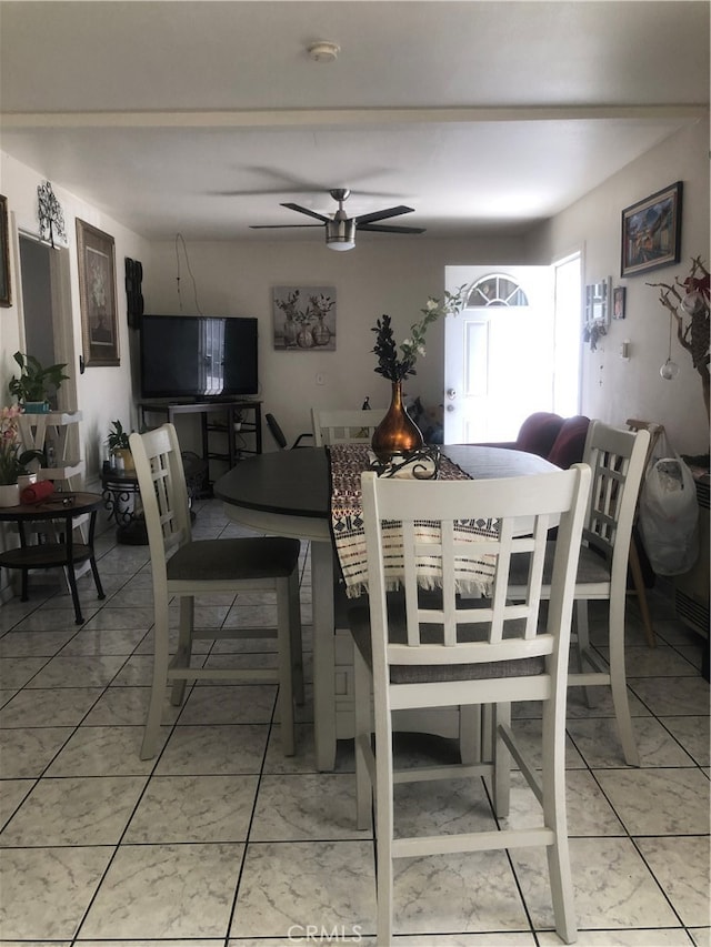 dining room featuring light tile floors and ceiling fan