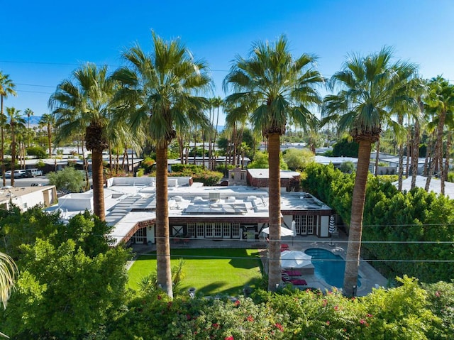 view of dock featuring a lawn, a patio area, and a swimming pool