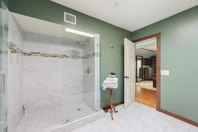 bathroom with an enclosed shower and hardwood / wood-style flooring