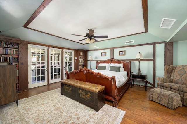 bedroom featuring access to exterior, ceiling fan, french doors, lofted ceiling, and hardwood / wood-style flooring