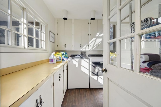 clothes washing area with cabinets, washing machine and dryer, and dark hardwood / wood-style floors