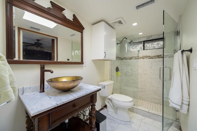 bathroom with toilet, vanity, and walk in shower