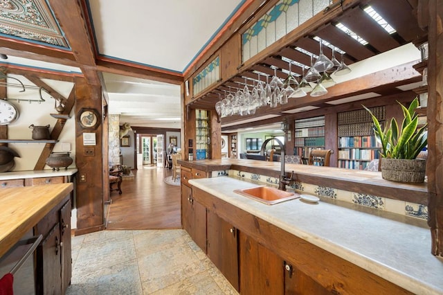 bathroom with wine cooler, hardwood / wood-style floors, beamed ceiling, and sink