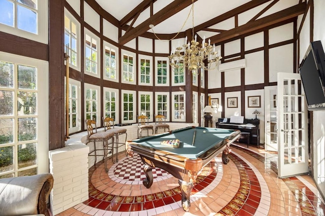 recreation room with beamed ceiling, a towering ceiling, a chandelier, and pool table