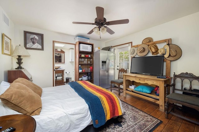 bedroom with dark hardwood / wood-style floors, ceiling fan, and stainless steel refrigerator with ice dispenser