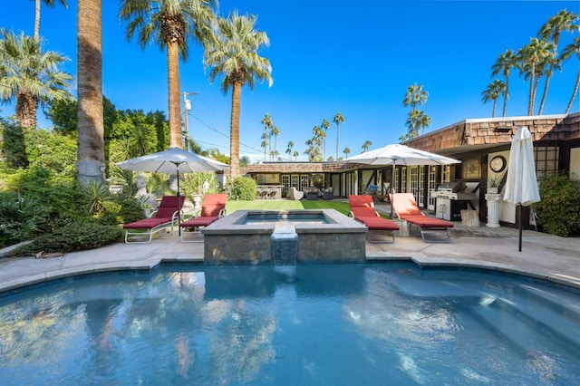 view of swimming pool with a patio area and an in ground hot tub