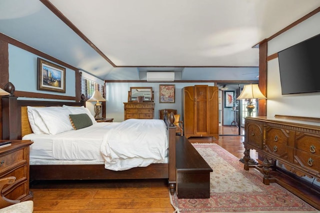 bedroom with an AC wall unit, dark wood-type flooring, and crown molding