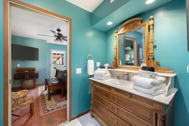 bathroom with ceiling fan, hardwood / wood-style floors, and vanity