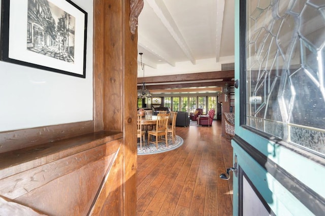 interior space with beamed ceiling and hardwood / wood-style flooring