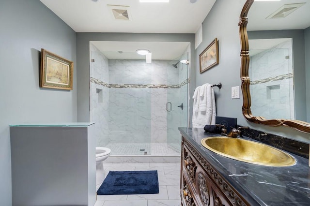 bathroom featuring vanity, toilet, and a shower with door