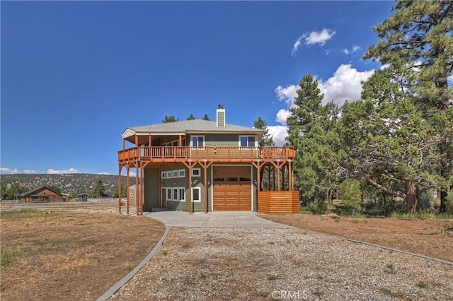 view of front of house with a deck and a garage