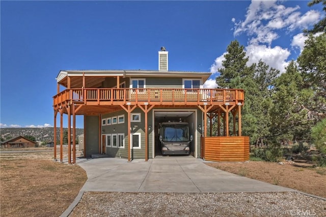 back of house featuring a carport and a wooden deck