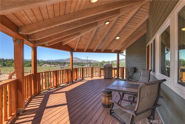 wooden terrace featuring a mountain view and grilling area