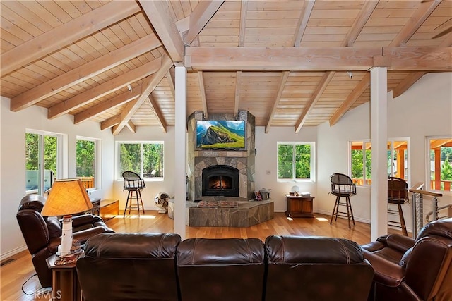 living room with wood ceiling, a fireplace, plenty of natural light, and light hardwood / wood-style floors