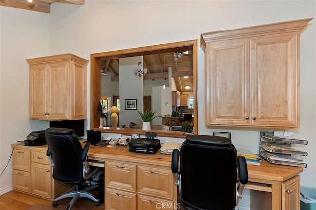 home office with wood ceiling, light hardwood / wood-style flooring, beamed ceiling, and built in desk