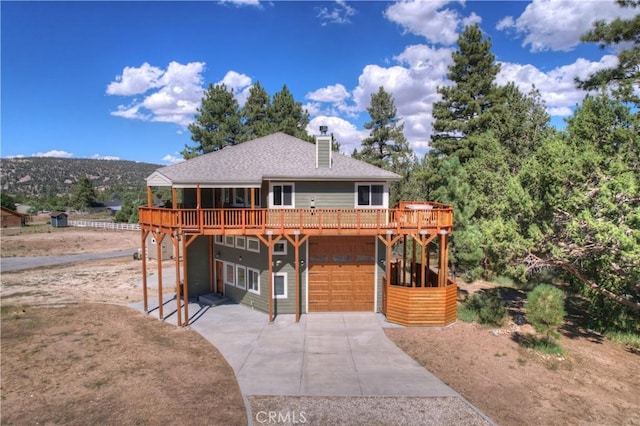 view of front facade with a wooden deck and a garage