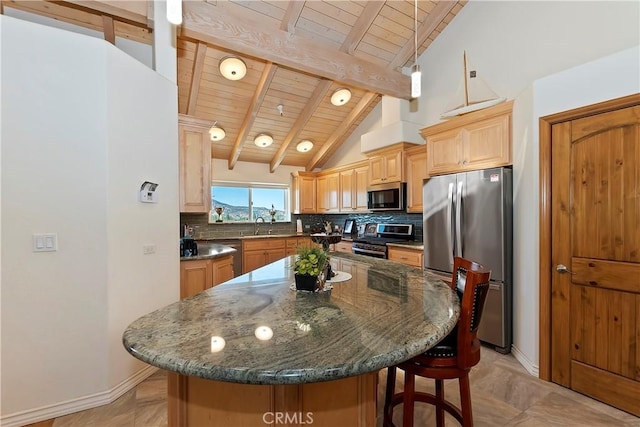 kitchen featuring lofted ceiling with beams, backsplash, a kitchen island, wood ceiling, and appliances with stainless steel finishes