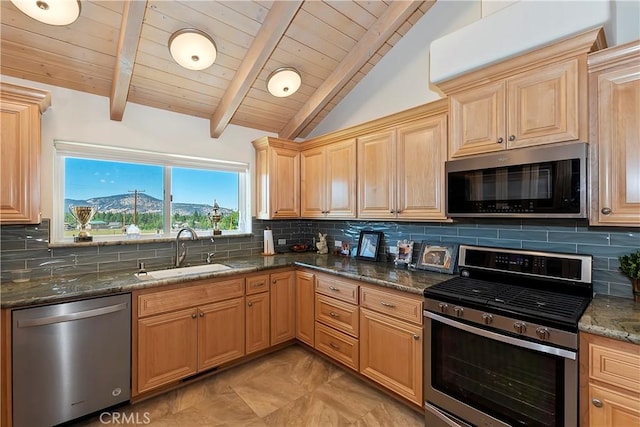 kitchen with appliances with stainless steel finishes, tasteful backsplash, sink, a mountain view, and vaulted ceiling with beams