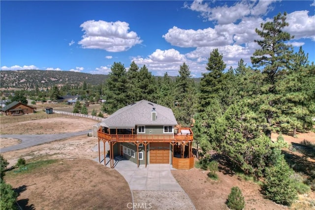 log home with a wooden deck and a garage