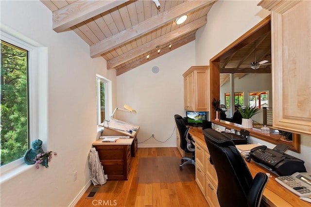 office area with vaulted ceiling with beams, ceiling fan, a healthy amount of sunlight, and light wood-type flooring