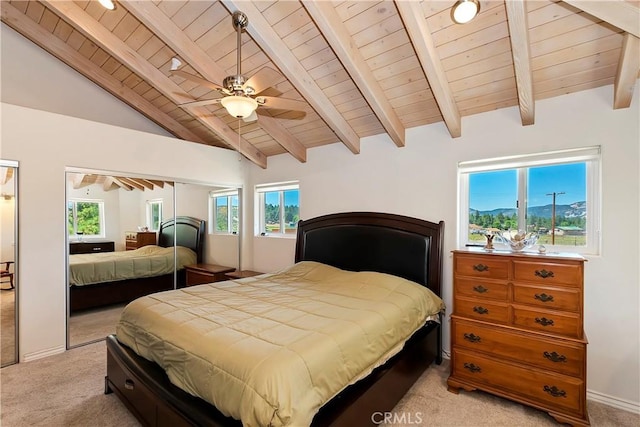 carpeted bedroom with ceiling fan, beamed ceiling, high vaulted ceiling, a closet, and wood ceiling