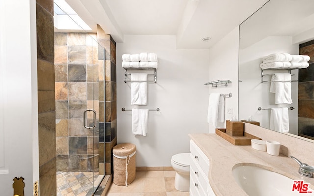 bathroom with tile floors, toilet, vanity, and a shower with door