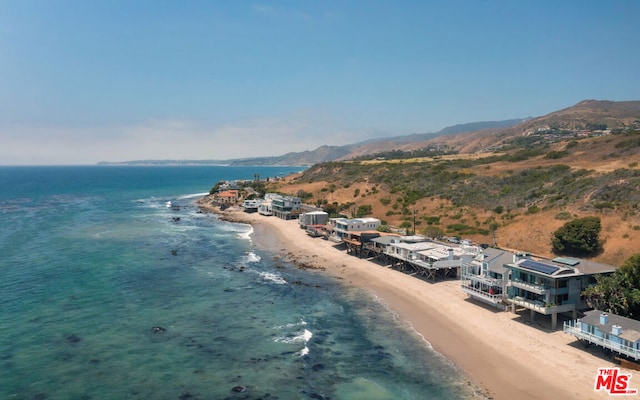 aerial view featuring a view of the beach and a water view