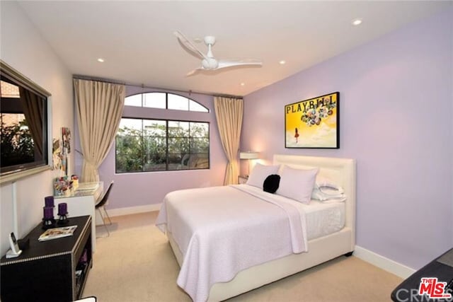 bedroom featuring ceiling fan and light carpet