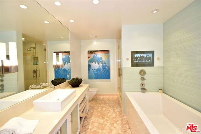 bathroom featuring vanity, shower with separate bathtub, and tile floors