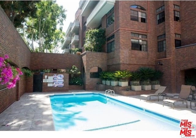 view of pool featuring a patio