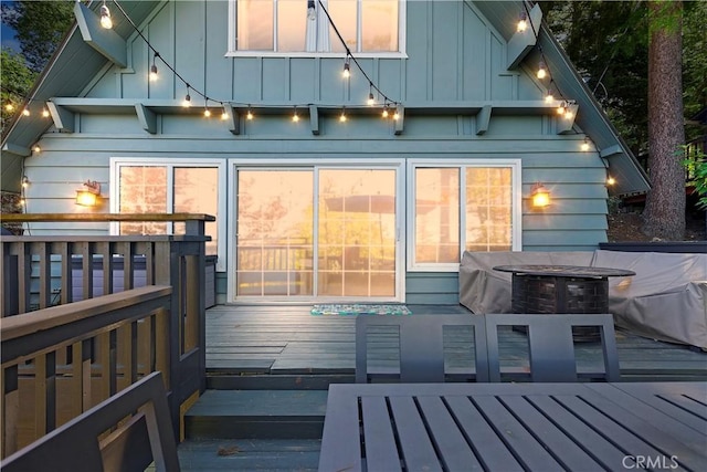 back of house featuring a wooden deck