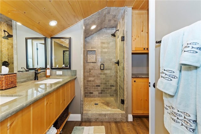 bathroom featuring wood-type flooring, vaulted ceiling, vanity, wood ceiling, and a shower with shower door